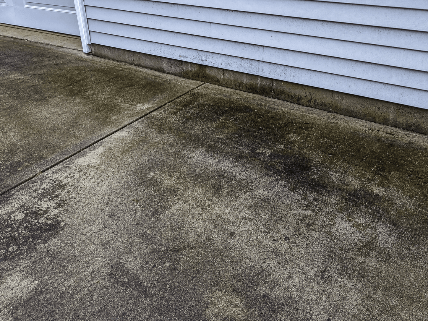 Weathered exterior surface before pressure washing